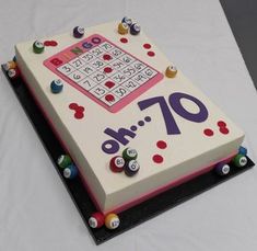 a sheet cake decorated with buttons and numbers