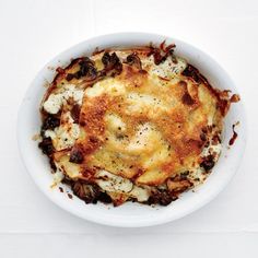 a white bowl filled with food on top of a table