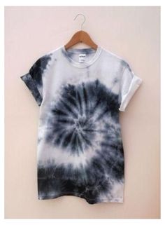 a black and white tie dye shirt hanging on a hanger