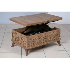 a coffee table with an open drawer on it's side and a wooden top