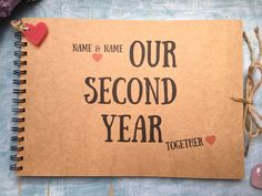 a brown notebook with the words, name and name our second year together on it