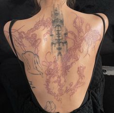 the back of a woman with tattoos on her body