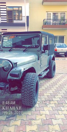 a jeep parked in front of a building