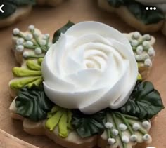 decorated cookies with white frosting and green leaves