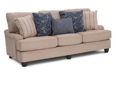 a beige couch with blue and white pillows