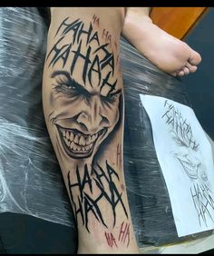 a man's leg with an evil joker tattoo on it and writing that says happy halloween