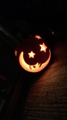 a carved pumpkin with the moon and stars on it