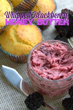 some muffins and blackberries are on a table next to a cupcake