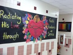 a large sign on the wall that says radiating his love through and rainbows and crayons