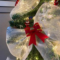 a christmas tree decorated with mesh bows and lights