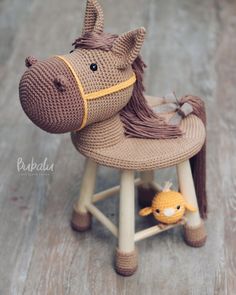 a toy horse sitting on top of a wooden stool