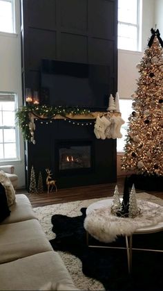 a living room with a christmas tree and fireplace