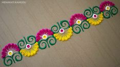 colorful flowers are arranged on the floor in an intricate pattern with white and yellow centers