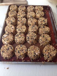 a pan filled with lots of cookies on top of a table