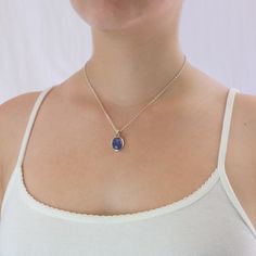 A delicate balance of rich blue and violet, this gem has fine crystal inclusions and an exquisite luster. Wearing this deep blue-hued beauty will add an elegant touch to any outfit. Known as the ‘stone of magic’ it brings its wearer the confidence to turn ideas into reality. Bringing the “will” to start and enhancing from beginning to end. This Tanzanite cabochon stone necklace is also great for Communication and Protection. Stone Origin: ﻿Tanzania Measures Approximately: 15 x 9 mm Materials: Ha Elegant Cabochon Sapphire Jewelry, Elegant Sapphire Cabochon Jewelry, Tanzanite Gemstone Round Pendant Jewelry, Tanzanite Gemstone Round Pendant, Blue Tanzanite Jewelry As A Gift, Blue Tanzanite Jewelry Perfect As A Gift, Sapphire Tanzanite Jewelry Gift, Elegant Blue Pendant Crystal Necklaces, Elegant Sapphire Jewelry With Cabochon