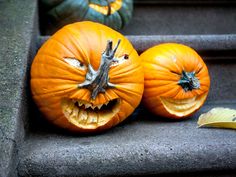 three pumpkins with faces carved into them sitting on the steps next to each other