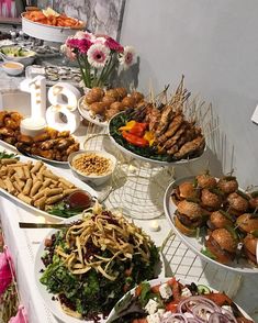 a buffet table filled with different types of food and snacks on plates next to each other