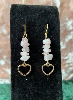 This listing is for one pair of earrings made from rose quartz crystals chips & gold heart charms attached to gold plated french ear wires. Rose quartz is a favorite crystal of the shop owner's, as it is a crystal representative of love. Rose quartz promotes healing & harmony, and is a great stone to help with maintaining loving relationships with oneself & others. Note: The appearance of the earrings, color, & exact measurements may vary, due to natural variations in the crystals. Simple Wire Bead Earrings, Crystal Stone Earrings, Quartz Earrings Diy, Halloween Crystal Jewelry, Small Handmade Earrings, Chip Bead Earrings, Crystal Chip Earrings, Gemstone Chip Earrings, Gold Rose Quartz Earrings For Gift