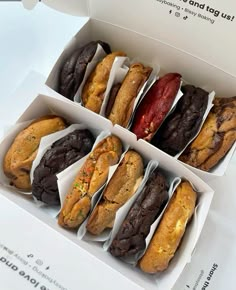 an open box filled with different types of cookies and muffins on top of each other