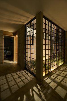 the sun shines through windows in an empty room with concrete walls and flooring