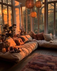 a living room filled with lots of windows and furniture next to a large window sill