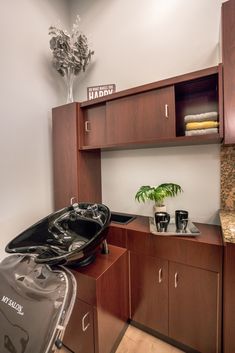 a bathroom with a sink, cabinets and a hair dryer