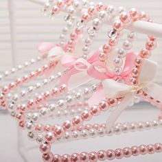 pink and white pearls are tied together with bows