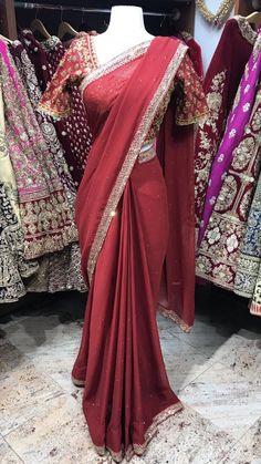 Maroon embroidered saree with stones. Stitched blouses, Peticoat and Fall Beeding included! Blouse style is same for entire order. Blouses are stitched to individual measurements but the shape of the neckline needs to be the same. For example- If you choose a sweetheart neckline all bridesmaids will have a sweetheart neckline but one bridesmaids can have the depth to be 8inches vs. the other can ask the neckline to be 10inches. Final fittings/alterations not included. Fabric - Georgette Our brid Traditional Drape Saree With Mirror Work, Designer Nida Sharara With Pallu, Elegant Art Silk Choli With Dabka Work, Saree With Unstitched Blouse For Reception, Festive Pre-draped Saree With Dabka Work For Diwali, Festive Chinon Choli With Dabka Work, Bollywood Designer Wear Choli With Dabka Work, Traditional Drape Blouse With Mirror Work, Bollywood Style Fitted Pre-draped Saree With Mirror Work