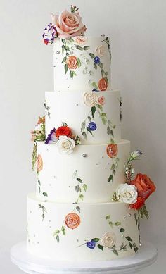 a three tiered wedding cake with flowers on it