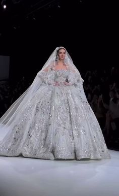 a woman in a wedding dress on the runway