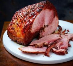 sliced ham sitting on top of a white plate