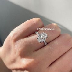 a woman's hand with a diamond ring on it