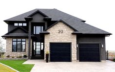 a large house with two garages on each side