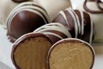 several chocolate covered desserts on a white plate