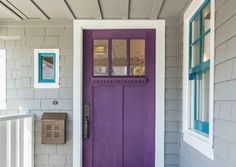 a purple front door on a gray house