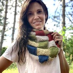 a woman wearing a multicolored scarf in the woods