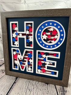 a wooden frame with the word home painted in red, white and blue stars