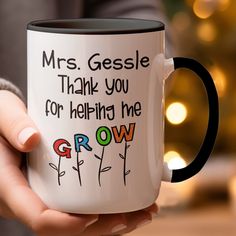 a person holding a coffee mug that says, mrs gessele thank you for helping me grow