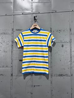 Size XSmall Vintage 70s Striped short Sleeve T Shirt women's Tight Fitting blue and yellow The shirt is in great shape with no holes, rips, and tears. Fits more like a size men's small or women's medium. See photos for condition. 14" across from armpit to armpit 32" length from shoulder to hem  Feel free to message with any questions. Thank you for looking! Follow on Instagram for more cool vintage @greatnorthernvintage b32 Yellow Retro Crew Neck Tops, Retro Striped Short Sleeve Shirt, Retro Mustard Cotton Top, Fitted Yellow Retro T-shirt, Retro Vertical Stripes Short Sleeve Shirt, Yellow Fitted Retro T-shirt, Vintage Striped Short Sleeve T-shirt, Cheap Vintage Striped T-shirt, Retro Yellow Short Sleeve T-shirt