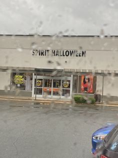 the front of a store with cars parked outside