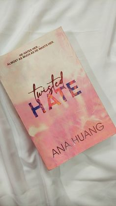 a book that is laying on top of a white sheet with the title twisted hate