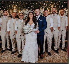 a bride and groom posing for a photo with their wedding party