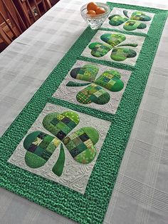 the table runner is made with green and white quilts