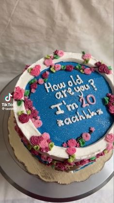 a blue cake with pink flowers on it