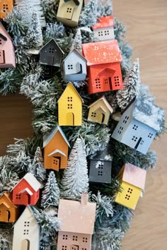 a christmas wreath with small houses on it