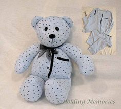 a white teddy bear with black polka dots on it's body sitting next to a piece of clothing