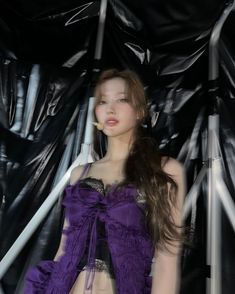 a woman with long hair wearing a purple dress