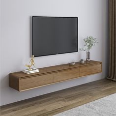 a flat screen tv mounted to the side of a wooden entertainment center in a living room