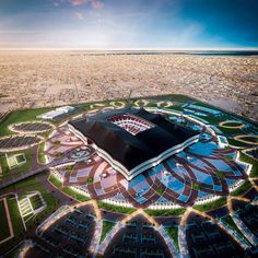 an aerial view of a stadium in the middle of a city with lots of buildings