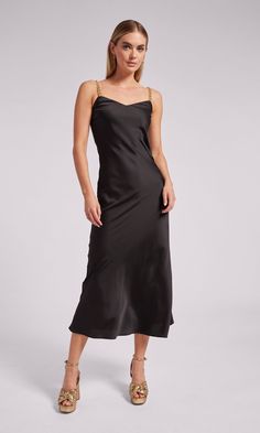 Go for a wow moment with the Monica. Crafted with soft satin in a maxi silhouette, this flowy dress features sleek chain straps that give it the perfect edge. Style with heels and gold jewelry and you'll be the best dressed guest at your next wedding or cocktail party. Product Fit & Details 100% Polyester Professional dry clean True to Size Style: SP24666-1 Model Size & FitModel wears a size XSModel wears: UK 6/ EU 34/ US 2Model's height: 177cm/5'10” Black Dress With Gold Heels, Black Dress Gold Heels, Luxury Black Slip Dress With Satin Finish, Dress With Chain Straps, Black Satin Finish Maxi Dress, Sleek Black Satin Finish Maxi Dress, Black Satin Floor-length Slip Dress, Black Floor-length Satin Maxi Dress, Satin Maxi